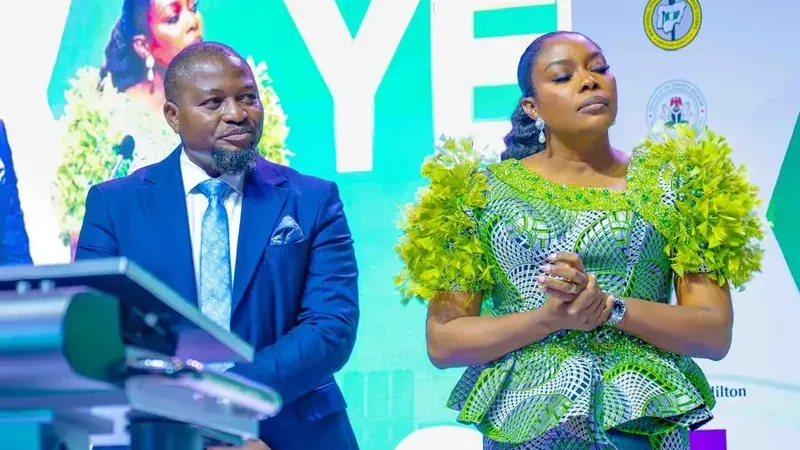 Uloko Fred speaking at a podium during a business summit